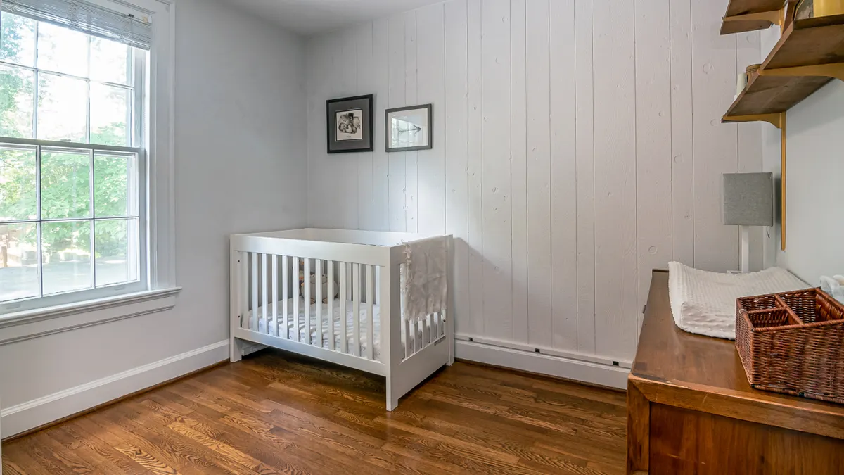 Crib and dresser in a clean nursery