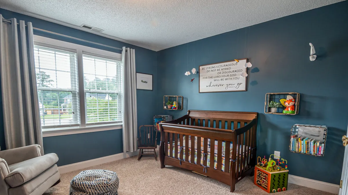 Baby crib in a decorated nursery room